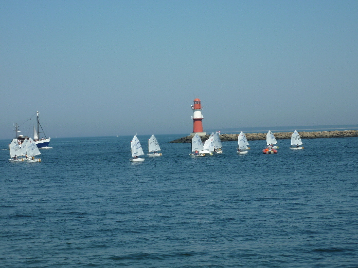 Roter Leuchturm Warnemnde / the red lighthouse of Warnemnde with some sailing boats and young sailsmen